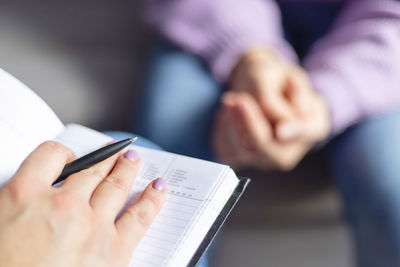 Midsection of man reading book