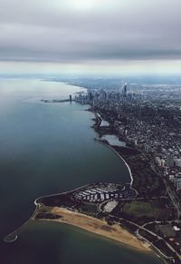 Aerial view of city by sea