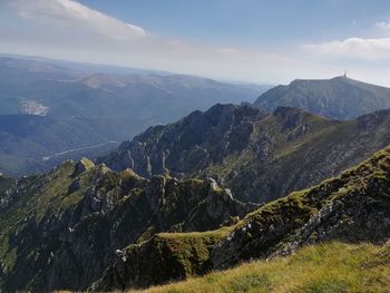 Scenic view of mountains against cloudy sky