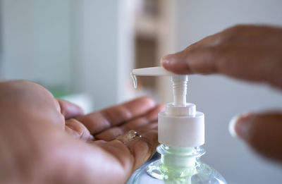 Close-up of man holding glass bottle