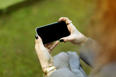 Midsection of man using mobile phone