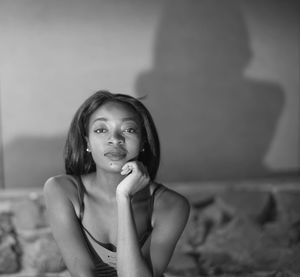 Portrait of young woman sitting at home