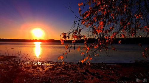 Scenic view of lake against sky during sunset