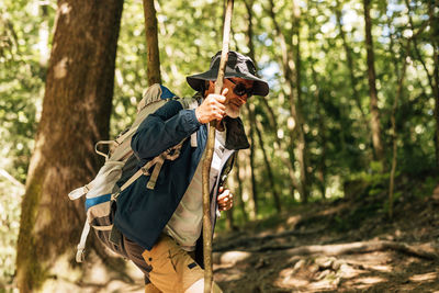 Senior man walking in forest