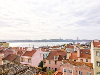 High angle view of houses in town against sky