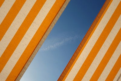 Low angle view of sunshade against clear sky