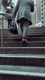 Low section of woman walking on steps