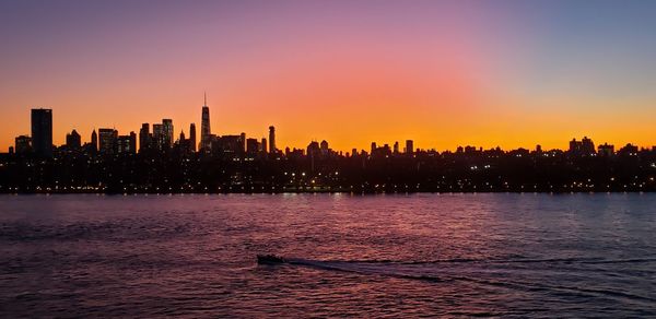 Scenic view of silhouette buildings against sky during sunset