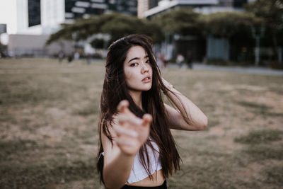 Portrait of young woman standing outdoors