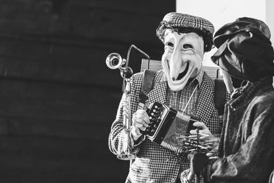 Ancient carnival of sauris. traditional wooden masks. black and white. italy