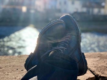 Close-up of shoes on sand