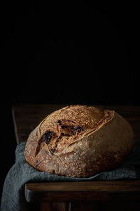 Close-up of cake on table against black background