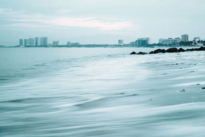 Scenic view of sea and buildings against sky