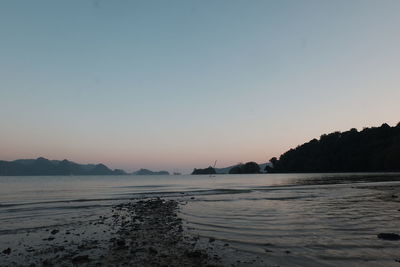 Scenic view of sea against clear sky during sunset