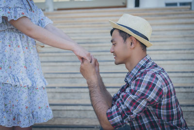 Midsection of couple standing outdoors