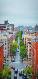 High angle view of street amidst buildings in city against sky