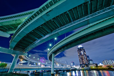 Low angle view of illuminated buildings against sky at night