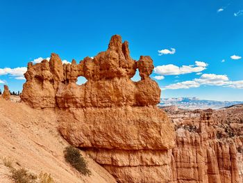 Low angle view of rock formations against sky