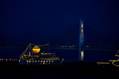 Low angle view of suspension bridge at night