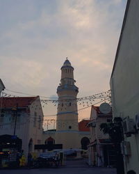 Low angle view of church against cloudy sky