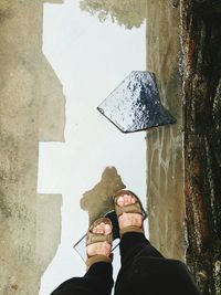 Low section of man walking in puddle