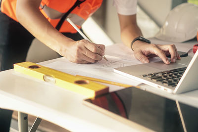 Low angle view of people working on table