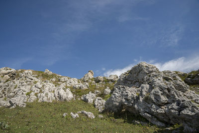 Low angle view of rocks against sky