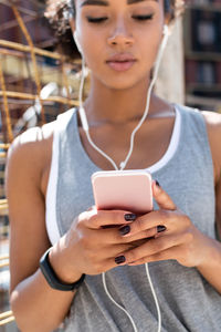 Close-up of man using mobile phone in city