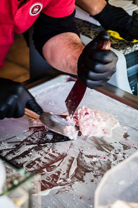 Midsection of man working on table