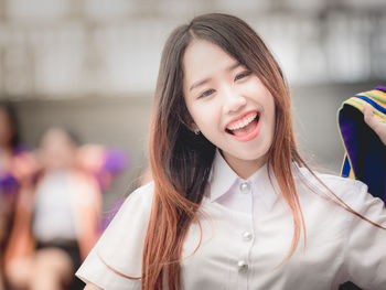 Portrait of smiling young woman standing outdoors