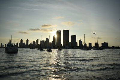 City at waterfront during sunset