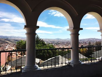 Buildings against sky seen from railing