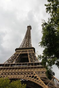 Low angle view of tower against cloudy sky