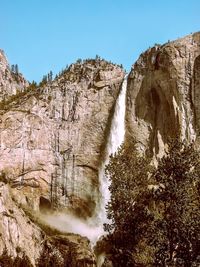 Scenic view of waterfall against sky