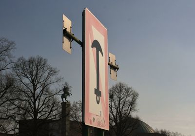 Low angle view of road sign against clear sky