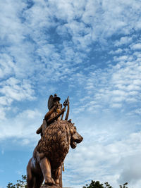 Low angle view of statue against sky