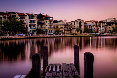 Reflection of buildings in river against sky