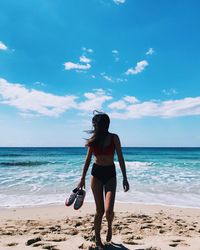 Full length of young woman on beach