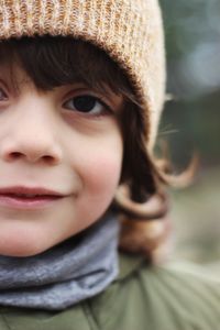 Close-up portrait of cute boy wearing knit hat