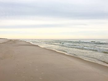 Scenic view of beach against sky during sunset