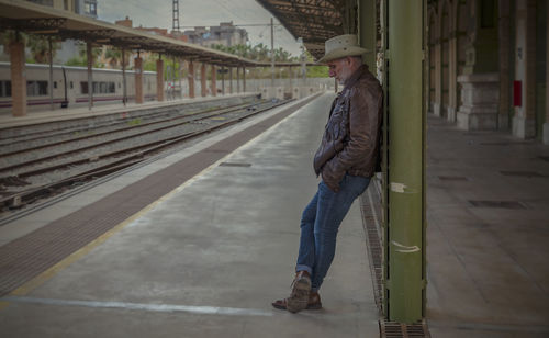 Portrait of adult man on cowboy hat waiting in train station. almeria, spain