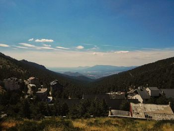 Houses by mountains against sky at puerto de navacerrada