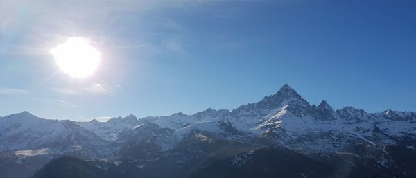 Scenic view of snowcapped mountains against sky