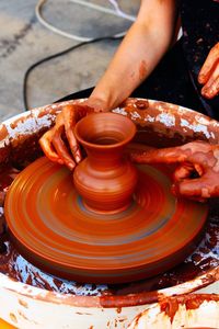 People making pottery on wheel