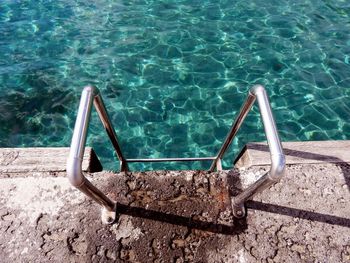 High angle view of ladder by swimming pool