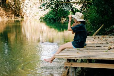 Full length of child on lake against trees