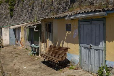 Abandoned house against building