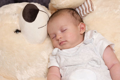 Cute baby boy sleeping on bed