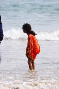 Side view of girl standing on beach