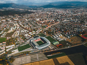 High angle view of illuminated city buildings against sky